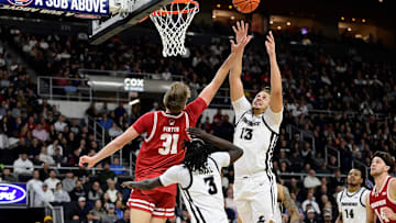 Nov 14, 2023; Providence, Rhode Island, USA; Providence Friars forward Josh Oduro (13) leaps for a rebound over Wisconsin Badgers forward Nolan Winter during the second half against the Wisconsin Badgers at Amica Mutual Pavilion.