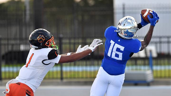 IMG Academy wide receiver Eric McFarland (#16) pulls in a pass in the end zone over Cocoa High free safety CJ Hester (#1) in the first quarter. The IMG Academy National squad hosted the Cocoa High School Tigers Friday, Sept. 6, 2024 in Bradenton.