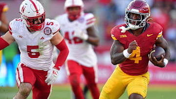 Nov 16, 2024; Los Angeles, California, USA; Southern California Trojans running back Woody Marks runs the ball ahead of Nebraska Cornhuskers linebacker John Bullock during the second half at the Los Angeles Memorial Coliseum.