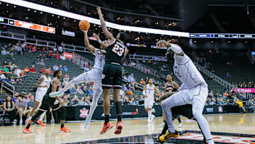 Mar 12, 2024; Kansas City, MO, USA; UCF Knights guard Shemarri Allen (2) shoots the ball around Brandon Garrison (23).