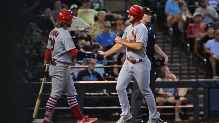 Jul 26, 2023; Phoenix, Arizona, USA;  St. Louis Cardinals shortstop Paul DeJong (11) celebrates with second baseman Brendan Donovan (33) after scoring in the seventh inning against the Arizona Diamondbacks at Chase Field. Mandatory Credit: Matt Kartozian-USA TODAY Sports