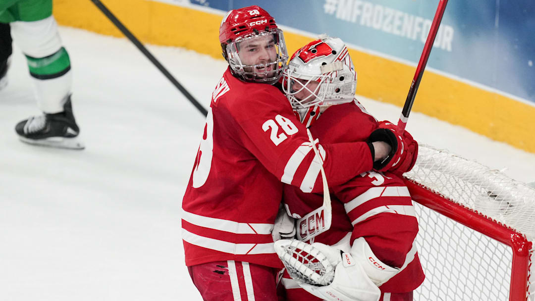 Apr 9, 2026; Las Vegas, Nevada, UNITED STATES; Wisconsin Badgers defenseman Aiden Dubinsky (28) celebrates with goalie Daniel Hauser (31) after defeating North Dakota Fighting Hawks in the semifinals of the NCAA men's ice hockey Frozen Four at T-Mobile Arena. Mandatory Credit: Lucas Peltier-Imagn Images