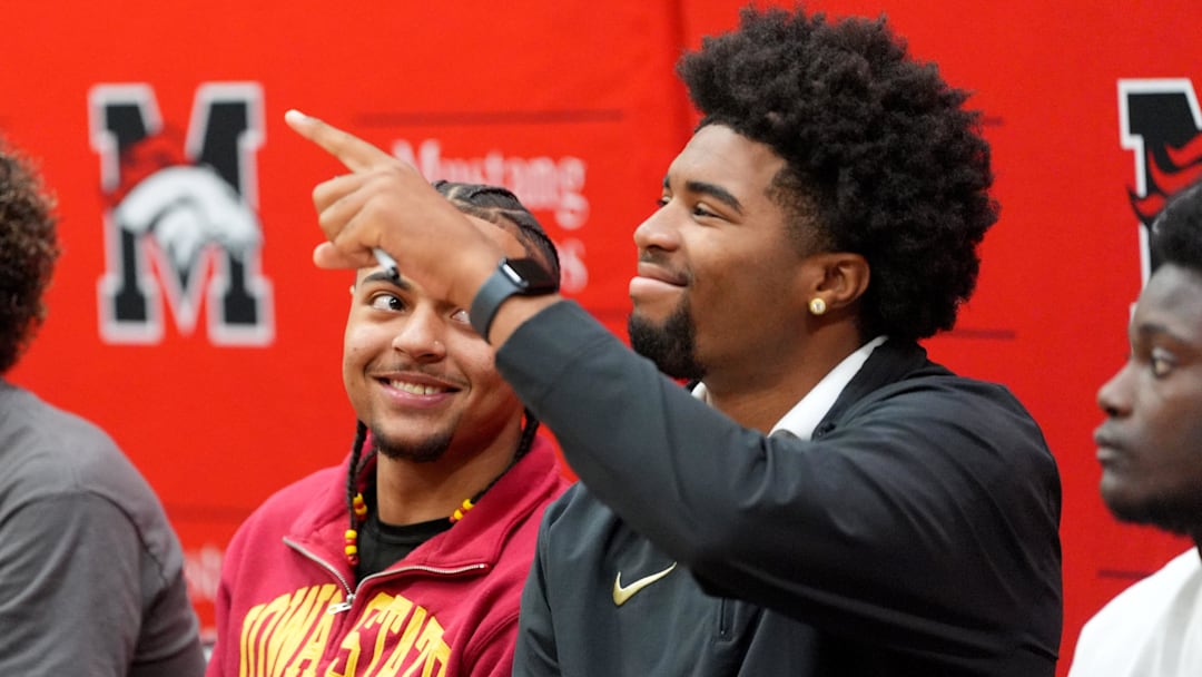 Mustang's Tayten Duncan, left, and Jaden O'Neal react during signing day ceremonies at Mustang High School in Mustang, Okla., Wednesday Dec. 3, 2025.