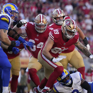 Nov 9, 2025; Santa Clara, California, USA; San Francisco 49ers running back Christian McCaffrey (23) runs the ball against Los Angeles Rams linebacker Byron Young (0) during the second quarter at Levi's Stadium. Mandatory Credit: Kyle Terada-Imagn Images
