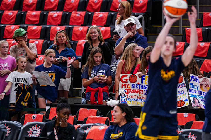  Indiana Fever fans look on as guard Caitlin Clark warms up before the start of the game against the Connecticut Sun.