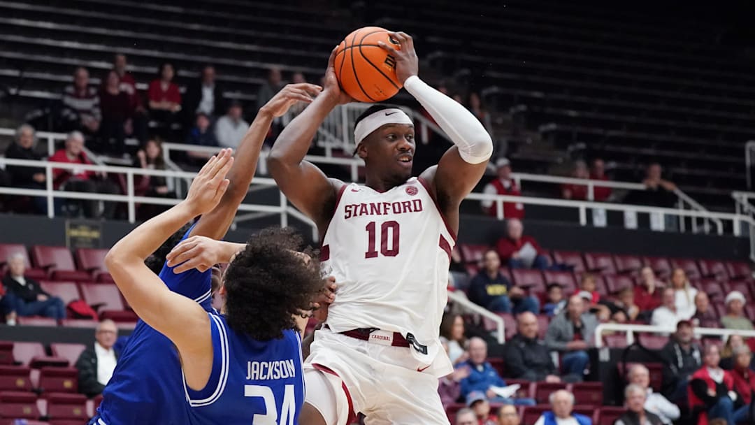Dec 17, 2025; Stanford, California, USA;  Stanford Cardinal forward Chisom Okpara (10) looks to pass over Texas-Arlington Mavericks forward/center Cameron Jackson (34) in the first half at Maples Pavilion. Mandatory Credit: David Gonzales-Imagn Images