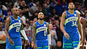 Nov 3, 2023; Milwaukee, Wisconsin, USA; Milwaukee Bucks center Khris Middleton (22), guard Damian Lillard (0) and forward Giannis Antetokounmpo (34) looks on during a timeout in the fourth quarter against the New York Knicks at Fiserv Forum. Mandatory Credit: Benny Sieu-Imagn Images