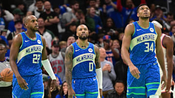 Nov 3, 2023; Milwaukee, Wisconsin, USA; Milwaukee Bucks center Khris Middleton (22), guard Damian Lillard (0) and forward Giannis Antetokounmpo (34) looks on during a timeout in the fourth quarter against the New York Knicks at Fiserv Forum. Mandatory Credit: Benny Sieu-Imagn Images