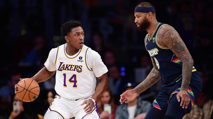 Apr 3, 2022; Los Angeles, California, USA; Los Angeles Lakers forward Stanley Johnson (14) moves the ball against Denver Nuggets center DeMarcus Cousins (4) during the first half at Crypto.com Arena. Mandatory Credit: Gary A. Vasquez-USA TODAY Sports