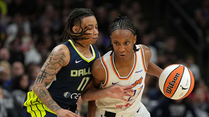Jul 7, 2025; Phoenix, Arizona, USA; Phoenix Mercury guard Kiana Williams drives on Dallas Wings guard JJ Quinerly (11) in the second half at Footprint Center. Mandatory Credit: Rick Scuteri-Imagn Images