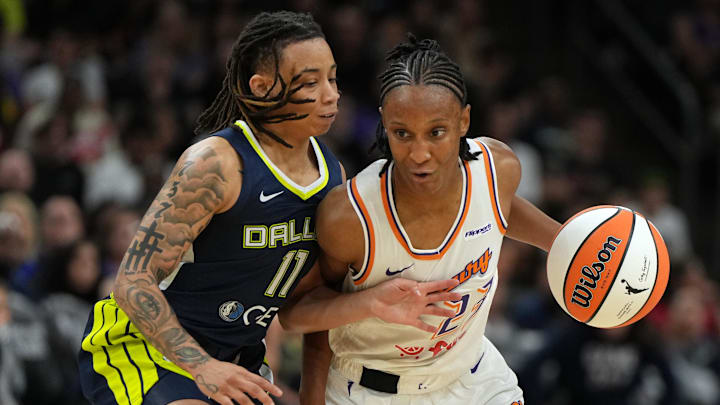 Jul 7, 2025; Phoenix, Arizona, USA; Phoenix Mercury guard Kiana Williams drives on Dallas Wings guard JJ Quinerly (11) in the second half at Footprint Center. Mandatory Credit: Rick Scuteri-Imagn Images