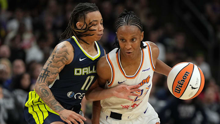 Jul 7, 2025; Phoenix, Arizona, USA; Phoenix Mercury guard Kiana Williams drives on Dallas Wings guard JJ Quinerly (11) in the second half at Footprint Center. Mandatory Credit: Rick Scuteri-Imagn Images
