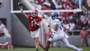 Oct 18, 2025; Athens, Georgia, USA; Georgia Bulldogs quarterback Gunner Stockton (14) looks to pass against Mississippi Rebels linebacker Tahj Chambers (26) during the first half of the game at Sanford Stadium. Mandatory Credit: Brett Davis-Imagn Images