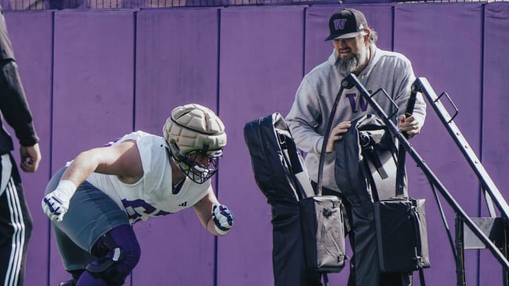 Brennan Carroll watches offensive tackle Aidan Anderson hit the sled. 