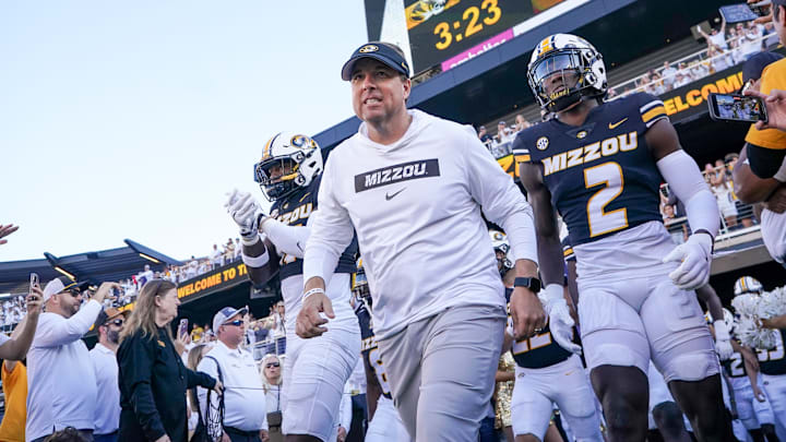 Sep 7, 2024; Columbia, Missouri, USA; Missouri Tigers head coach Eli Drinkwitz runs out with the team against the Buffalo Bulls prior to a game at Faurot Field at Memorial Stadium.