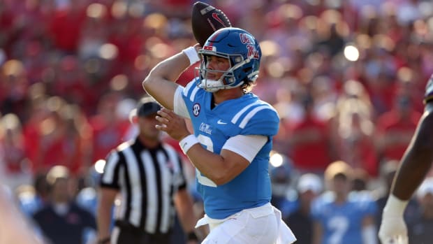 Ole Miss Rebels quarterback Jaxson Dart attempts a pass during a college football game in the SEC.