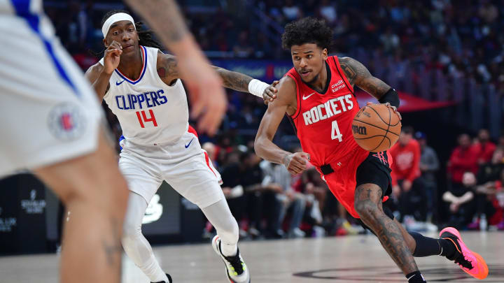 Apr 14, 2024; Los Angeles, California, USA; Houston Rockets guard Jalen Green (4) moves the ball against Los Angeles Clippers guard Terance Mann (14) during the first half at Crypto.com Arena. Mandatory Credit: Gary A. Vasquez-USA TODAY Sports