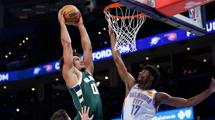 Oct 7, 2026; Oklahoma City, Oklahoma, USA; Milwaukee Bucks center Jericho Sims (00) goes up for a dunk beside Oklahoma City Thunder forward Andrew Holifield (17) during the second half of a preseason game at Paycom Center. Mandatory Credit: Alonzo Adams-Imagn Images