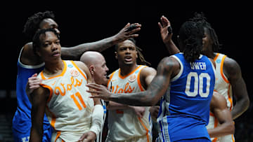 Mar 28, 2025; Indianapolis, IN, USA;Tennessee Volunteers guard Jordan Gainey (11) and Kentucky Wildcats guard Otega Oweh (00) shove each other  in the second half during a Midwest Regional semifinal of the 2025 NCAA tournament at Lucas Oil Stadium. Mandatory Credit: Robert Goddin-Imagn Images