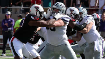 Oct 23, 2021; Lubbock, Texas, USA;  Kansas State Wildcats offensive lineman Cooper Beebe (50) blocks Texas Tech Red Raiders defensive lineman Tyree Wilson (19) in the first half at Jones AT&T Stadium. Mandatory Credit: Michael C. Johnson-USA TODAY Sports