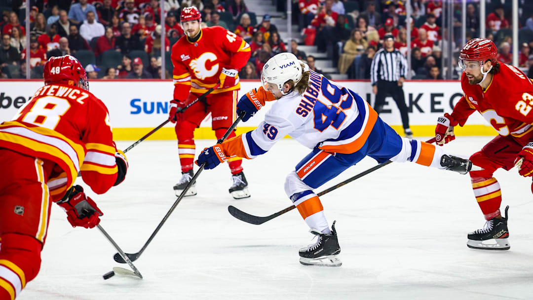 Jan 17, 2026; Calgary, Alberta, CAN; New York Islanders right wing Maxim Shabanov (49) shoots the puck against the Calgary Flames during the first period at Scotiabank Saddledome. Mandatory Credit: Sergei Belski-Imagn Images