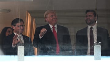 Dec 14, 2024; Landover, Maryland, USA; U.S. President-elect Donald Trump (center), Vice President-elect JD Vance (right), and Speaker of the House Mike Johnson (left) look on during the Navy vs Army game at Northwest Stadium. Mandatory Credit: Tommy Gilligan-Imagn Images