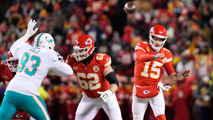 Jan 13, 2024; Kansas City, Missouri, USA; Kansas City Chiefs quarterback Patrick Mahomes (15) throws as guard Joe Thuney (62) provides coverage against Miami Dolphins defensive tackle Da'Shawn Hand (93) during the second half of the 2024 AFC wild card game at GEHA Field at Arrowhead Stadium. Mandatory Credit: Jay Biggerstaff-Imagn Images