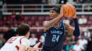 Dec 3, 2023; Stanford, California, USA; San Diego Toreros center Steven Jamerson II (24) looks to pass the ball against Stanford Cardinal forward Maxime Raynaud (42) during the second half at Maples Pavilion. Mandatory Credit: Robert Edwards-Imagn Images