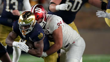 Indiana Hoosiers defensive lineman James Carpenter (99) tackles Notre Dame Fighting Irish running back Jadarian Price (24) during the first half of a game between the Indiana Hoosiers and the Notre Dame Fighting Irish in first round of the College Football Playoff on Friday, Dec. 20, 2024, in South Bend. Notre Dame defeated Indiana 27-17.