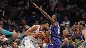 Mar 20, 2025; Charlotte, North Carolina, USA; New York Knicks center Karl-Anthony Towns (32) presses against Charlotte Hornets forward Moussa Diabate (14) during the second half at Spectrum Center. Mandatory Credit: Jim Dedmon-Imagn Images