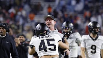 Nov 8, 2025; Charlottesville, Virginia, USA; Wake Forest Demon Deacons head coach Jake Dickert (center) chest bumps Demon Deacons defensive back Nick Andersen (45) after the Demon Deacons blocked a touchdown pass in the final seconds of the second half against the Virginia Cavaliers at Scott Stadium. Mandatory Credit: Amber Searls-Imagn Images