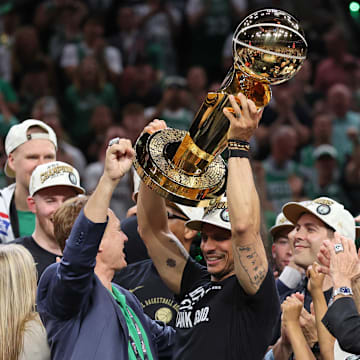 Jun 17, 2024; Boston, Massachusetts, USA; Boston Celtics head coach Joe Mazzulla holds up the trophy as he celebrates after winning the 2024 NBA Finals against the Dallas Mavericks at TD Garden. Mandatory Credit: Peter Casey-Imagn Images