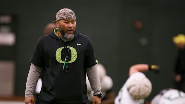 Oregon defensive line coach Tony Tuioti leads practice with the Ducks  