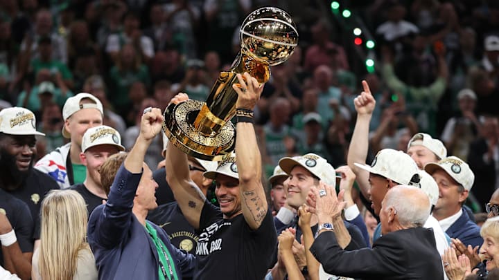 Jun 17, 2024; Boston, Massachusetts, USA; Boston Celtics head coach Joe Mazzulla holds up the trophy as he celebrates after winning the 2024 NBA Finals against the Dallas Mavericks at TD Garden. Mandatory Credit: Peter Casey-Imagn Images