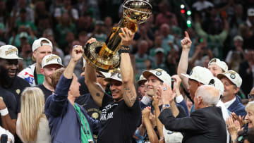 Jun 17, 2024; Boston, Massachusetts, USA; Boston Celtics head coach Joe Mazzulla holds up the trophy as he celebrates after winning the 2024 NBA Finals against the Dallas Mavericks at TD Garden. Mandatory Credit: Peter Casey-USA TODAY Sports