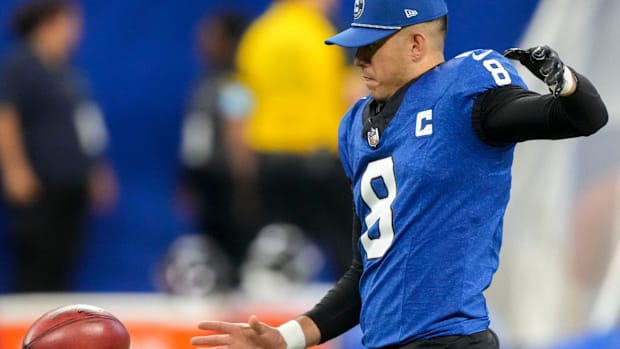 Colts punter Rigoberto Sanchez (blue jersey) warms up before a game starts.