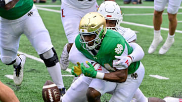 Sep 28, 2024; South Bend, Indiana, USA; Notre Dame Fighting Irish running back Jadarian Price (24) fumbles against the Louisville Cardinals in the second quarter at Notre Dame Stadium. Mandatory Credit: Matt Cashore-Imagn Images