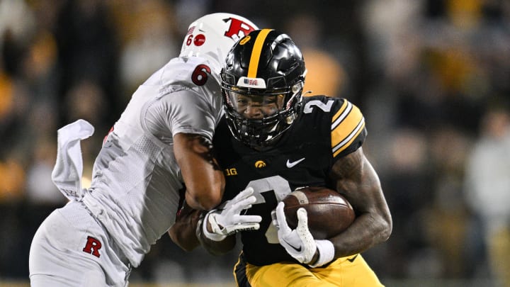 Nov 11, 2023; Iowa City, Iowa, USA; Iowa Hawkeyes running back Kaleb Johnson (2) runs the ball as Rutgers Scarlet Knights defensive back Shaquan Loyal (6) goes for the tackle during the fourth quarter at Kinnick Stadium. Mandatory Credit: Jeffrey Becker-USA TODAY Sports