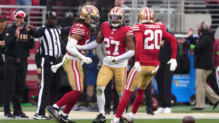 Dec 10, 2023; Santa Clara, California, USA; San Francisco 49ers safety Ji'Ayir Brown (27) is congratulated by linebacker Fred Warner (54) and cornerback Ambry Thomas (20) after intercepting a pass against the Seattle Seahawks during the fourth quarter at Levi's Stadium. Mandatory Credit: Darren Yamashita-USA TODAY Sports