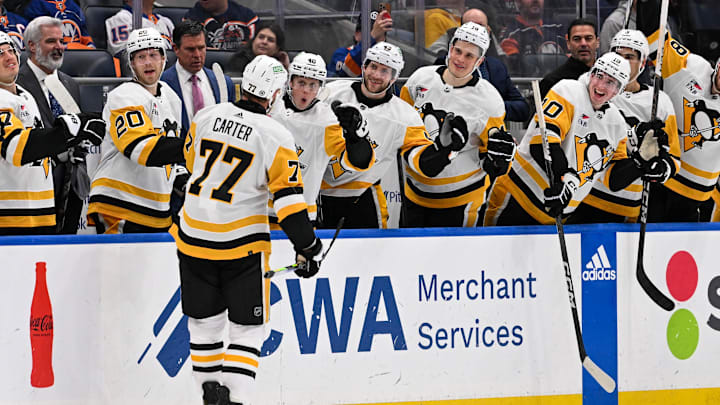 Apr 17, 2024; Elmont, New York, USA;  Pittsburgh Penguins center Jeff Carter (77) celebrates a goal against the New York Islanders with the bench during the third period at UBS Arena. Mandatory Credit: Dennis Schneidler-Imagn Images