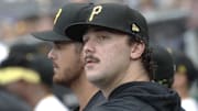 Sep 26, 2024; Pittsburgh, Pennsylvania, USA;  Pittsburgh Pirates pitchers Jared Jones (left) and Paul Skenes (right) look on from the dugout against the Milwaukee Brewers during the third inning at PNC Park. Mandatory Credit: Charles LeClaire-Imagn Images