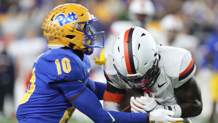Nov 9, 2024; Pittsburgh, Pennsylvania, USA; Virginia Cavaliers wide receiver Andre Greene Jr. is tackled after a catch by Pittsburgh Panthers defensive back Ryland Gandy (10) during the first quarter at Acrisure Stadium. Mandatory Credit: Charles LeClaire-Imagn Images Nov 9, 2024; Pittsburgh, Pennsylvania, USA; Virginia Cavaliers wide receiver Andre Greene Jr. is tackled after a catch by Pittsburgh Panthers defensive back Ryland Gandy (10) during the first quarter at Acrisure Stadium. Mandatory Credit: Charles LeClaire-Imagn Images