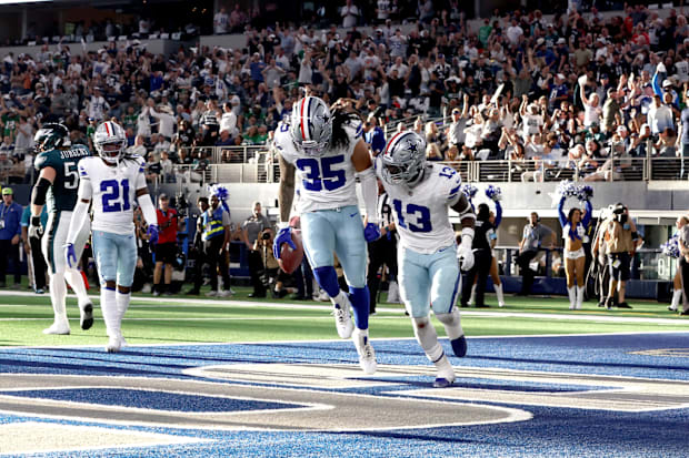 Dallas Cowboys linebackers Marist Liufau and DeMarvion Overshown react to recovering a fumble.