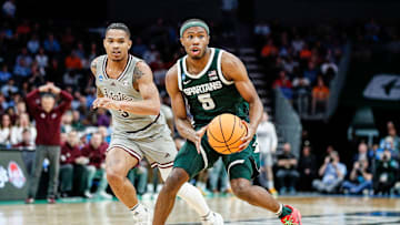 Michigan State guard Tre Holloman (5) looks to pass against Mississippi State guard Shakeel Moore