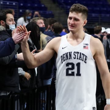 Penn State men's basketball player John Harrar greets fans after a Nittany Lions victory at the Bryce Jordan Center. 