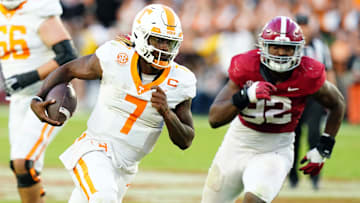 Oct 21, 2023; Tuscaloosa, Alabama, USA; Tennessee Volunteers quarterback Joe Milton III (7) scrambles with the ball against the Alabama Crimson Tide during the second half at Bryant-Denny Stadium. Mandatory Credit: John David Mercer-Imagn Images