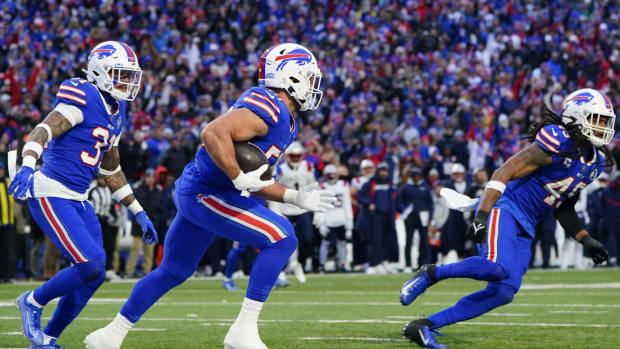 Matt Milano (58) runs with the ball after making an interception against the New England Patriots during the second half.