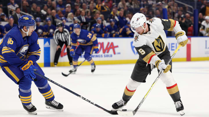 Nov 10, 2022; Buffalo, New York, USA;  Buffalo Sabres defenseman Ilya Lyubushkin (46) knocks the puck off the stick of Vegas Golden Knights center Jack Eichel (9) during the third period at KeyBank Center. Mandatory Credit: Timothy T. Ludwig-USA TODAY Sports