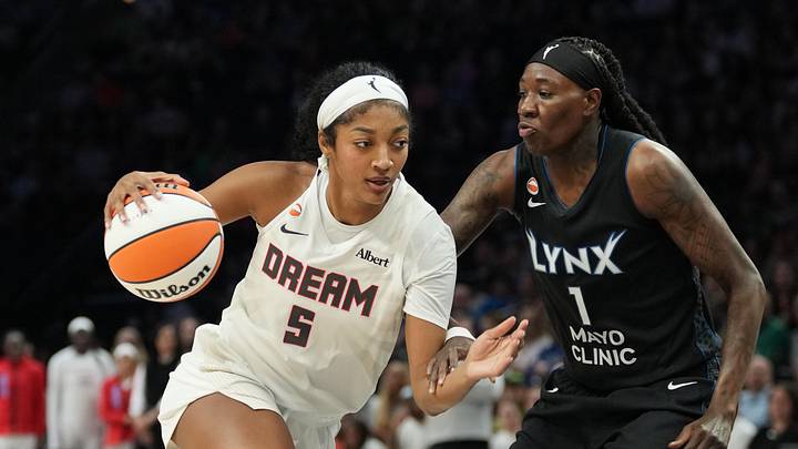 May 27, 2026; Minneapolis, Minnesota, USA; Atlanta Dream forward Angel Reese (5) dribbles the ball as Minnesota Lynx forward Natasha Howard (1) plays defense in the first half at Target Center. Mandatory Credit: Jesse Johnson-Imagn Images