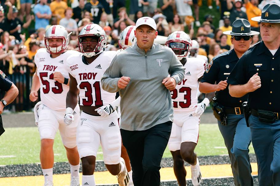 Troy head coach Jon Sumrall runs on the field before a 2022 game against Appalachian State.